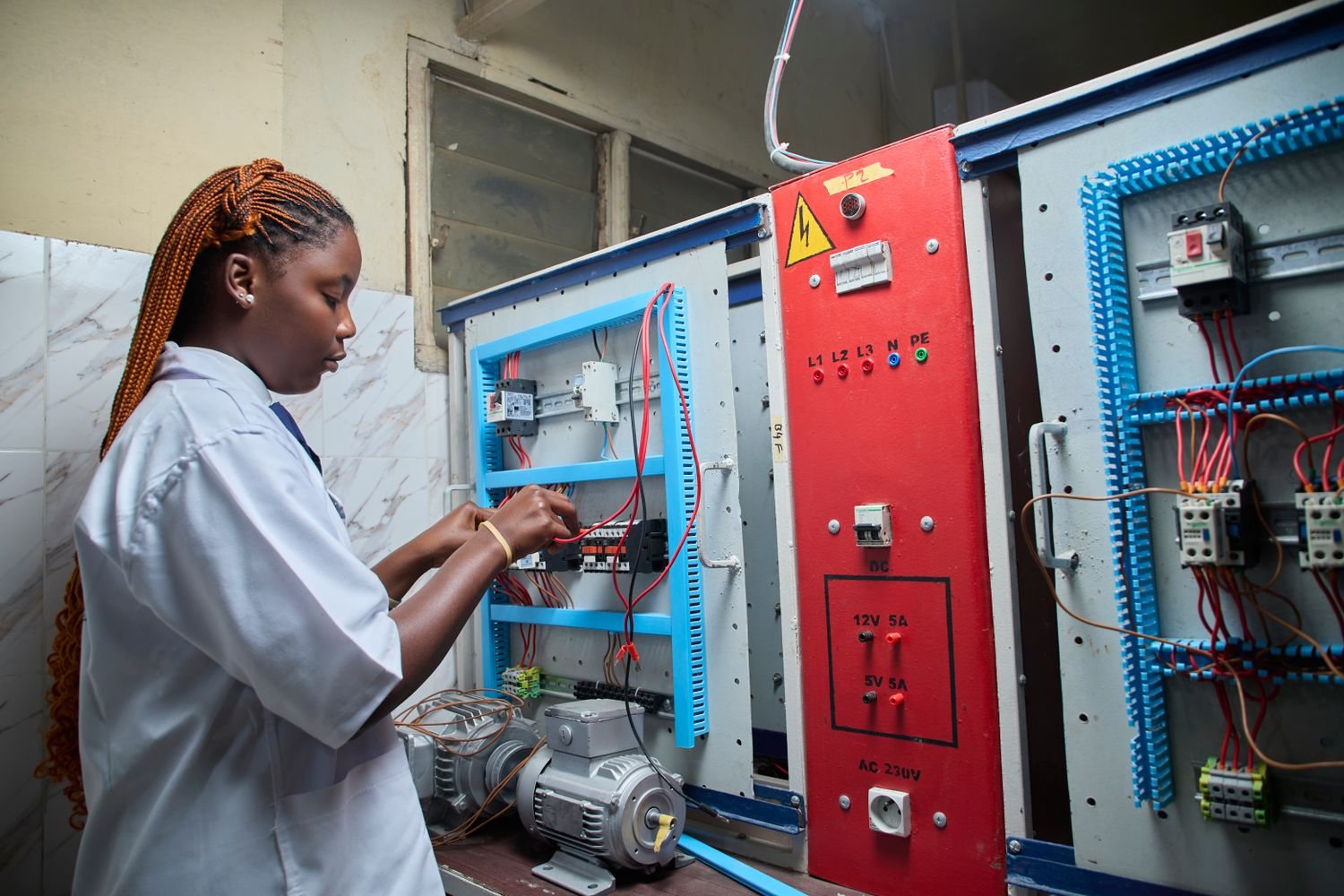 Technician running instrument tests on an electrical panel
