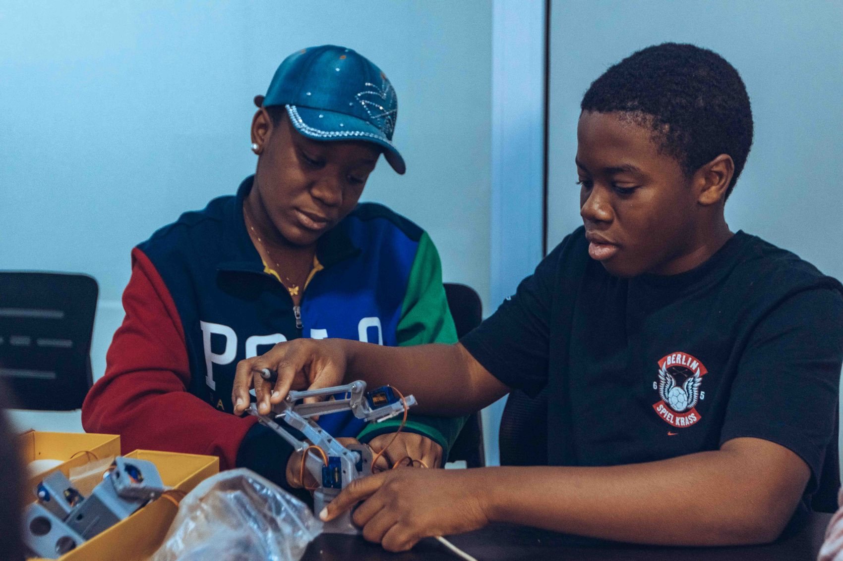 A Tlou Foundation College facilitator guiding a learner at a workstation