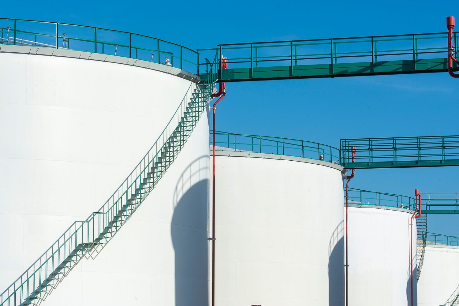 Bulk petroleum storage tanks under a clear sky